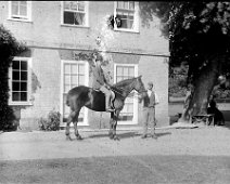 Ernest on Gypsy (with groom) at Sedgeford Hall Ernest on horse back Original caption: Young man on a horse (with groom)