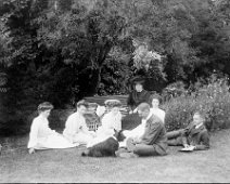 Group of ladies and men on front lawn Original caption: Group of ladies and men on front lawn