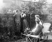 Family chatting over garden fence Comment on the back of a copy of this picture in the Woodgate box :- Folkestone Auntie Emmie, Claud, Uncle Alec talking to G.O.H. N.I.H., H.V.H. & G.M.H. 1904...