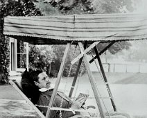 Mr. Hunt on hammock chair, Sedgeford Hall Original caption: Mr. Hunt on hammock chair