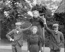 Mr. Bovis & Gerald holding ladder with 3 girls & Frank on it, Sedgeford Hall Original caption: Mr. Bovis and Gerald holding ladder with 3 girls and Frank on it