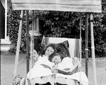 Gertie & Nona in hammock chair, Sedgeford Hall Original caption: Gertie and Nona in hammock chair