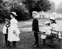 Children & mail-cart Original caption: Children and mail-cart