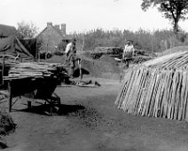 Charcoal burners stack and wheelbarrow Original caption: Charcoal burners stack and wheelbarrow