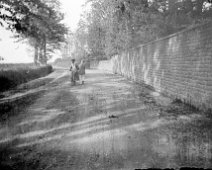 Man holding girl on bicycle Very likely taken on Lodge Road, Heacham. The number of courses match. Original caption: Man holding girl on bicycle