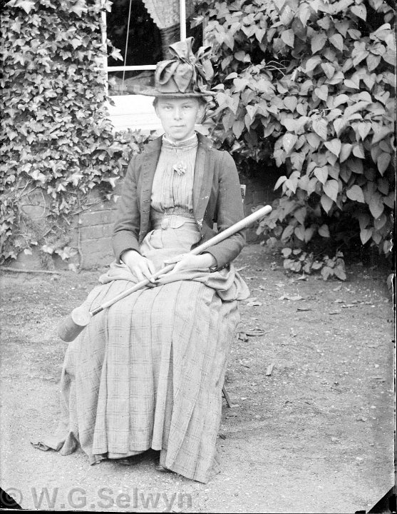 A lady with a croquet mallet Original caption: A lady with a broom