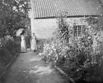 2 ladies near a cottage Original caption: 2 ladies near a cottage