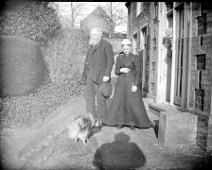 An old man and a lady Rev Ogle and his wife at rear of vicarage, Church Lane, Sedgeford Original caption: An old man and a lady