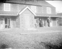 Father and 2 others by a house being built Father and Rev Ogle and wife outside Brookdale, Church Lane, Sedgeford Original caption: Father and 2 others by a house being built