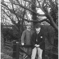 Father and Mr. Kennedy by shrubbery gate Original caption: Father and Mr. Kennedy by shrubbery gate