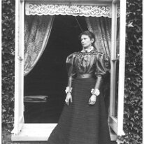 Gracie in drawing room window, Sedgeford Hall Original caption: Gracie (Grace Mary Hunt d. of Alfred Simon Hunt) in drawing room window
