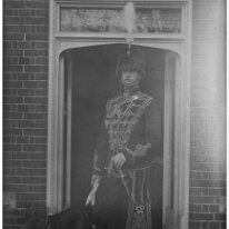 One in uniform with dog Probably Reggie (maybe at Hart Hill) Original caption: One in uniform with dog