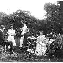 Group having tea on lawn Original caption: Group having tea on lawn