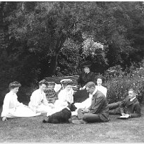 Group of ladies and men on front lawn Original caption: Group of ladies and men on front lawn