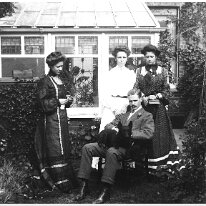 3 girls , gent and a dog in a garden Original caption: 3 girls , gent and a dog in a garden