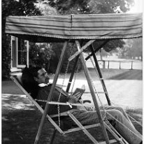 Mr. Hunt on hammock chair, Sedgeford Hall Original caption: Mr. Hunt on hammock chair