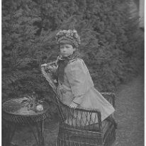 Nona on wicker chair Original caption: Nona on wicker chair