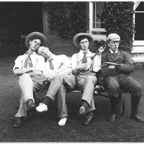 Gilbert + 3 others on bench with tennis raquets outside the drawing room window, Sedgeford Hall Original caption: Gilbert + 3 others on bench with tennis raquets