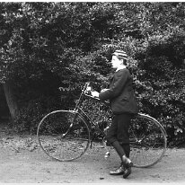 John with his bicycle Original caption: John with his bicycle