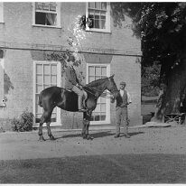 Ernest on Gypsy (with groom) at Sedgeford Hall Original caption: Young man on a horse (with groom)