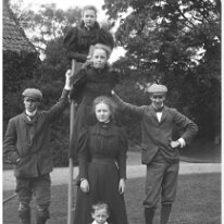 Mr. Bovis & Gerald holding ladder with 3 girls & Frank on it, Sedgeford Hall Original caption: Mr. Bovis and Gerald holding ladder with 3 girls and Frank on it