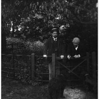 Father and Mr. Long by shrubbery gate Original caption: Father and Mr. Long by shrubbery gate
