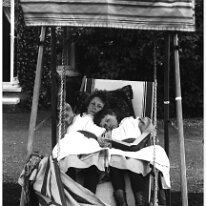 Gertie & Nona in hammock chair, Sedgeford Hall Original caption: Gertie and Nona in hammock chair