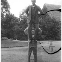 Reggie holding Gilbert on ladder Sedgeford Hall Original caption: Reggie holding Gilberton ladder