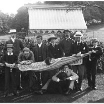 Large group, Mr. B.Case and Mr. Palmer, etc. under awning Original caption: Large group, Mr. B.Case and Mr. Palmer, etc. under awning
