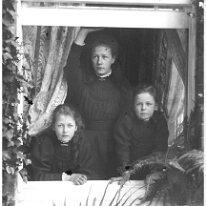 3 girls in window Original caption: 3 girls in window
