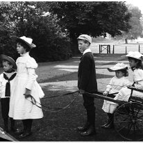 Children & mail-cart Original caption: Children and mail-cart