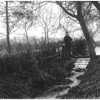 Mr. H. on bridge Sedgeford Hall park Original caption: Mr. H. on bridge