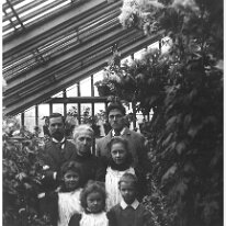 Family group in greenhouse, Sedgeford Hall in Sedgeford Hall greenhouse Original caption: Family group in greenhouse