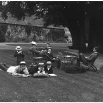 Family studying on lawn Sedgeford Hall Original caption: Family studying on lawn