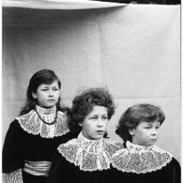3 girls in red frocks Original caption: 3 girls in red frocks
