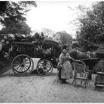 Mrs. Grey with her basket cart On Fring Lane by Sedgeford Hall garden wall Original caption: Mrs. Grey with her basket cart