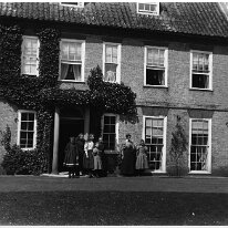 Sedgeford front door with group Original caption: Sedgeford front door with group