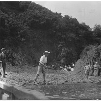 Family on a rocky beach Original caption: Family on a rocky beach