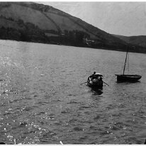 Father + 2 in a dinghy Original caption: Father + 2 in a dinghy