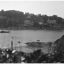 View over Salcombe Harbour The house with the tower is Cliff House. Maybe taken from just above Smalls Cove Original caption: View of harbour and cliff town
