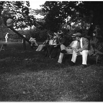 Family in the orchard. two on see-saw Original caption: Family in the orchard. two on see-saw
