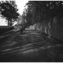 Man holding girl on bicycle Very likely taken on Lodge Road, Heacham. The number of courses match. Original caption: Man holding girl on bicycle