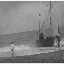 Boy padddling. Fishing boat Original caption: Boy padddling. Fishing boat
