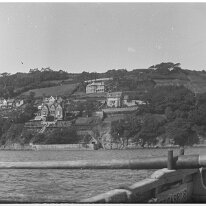 View of south Salcombe from rowing boat Sunny Cliff Hotel, Herwood, maybe Wood Grange on the skyline Original caption: View of coastline from rowing boat