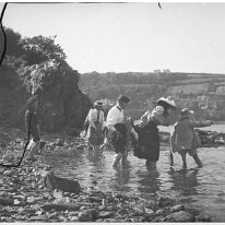 Family group paddling in sea Original caption: Family group paddling in sea