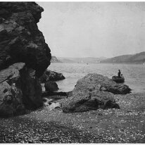 Man fishing in boat off shore Splat Cove (partially written in bottom LH corner) looking up estuary toward Salcombe Original caption: Man fishing in boat off shore