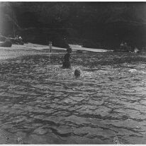 Sunny cove Original caption: Group swimming