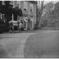 Dog cart by front door Sedgeford Hall Original caption: Dog cart by front door