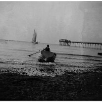 Rowing boat, sailing boat and Hunstanton Pier Original caption: Rowing boat, sailing boat, and a pier