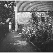 2 ladies near a cottage Original caption: 2 ladies near a cottage